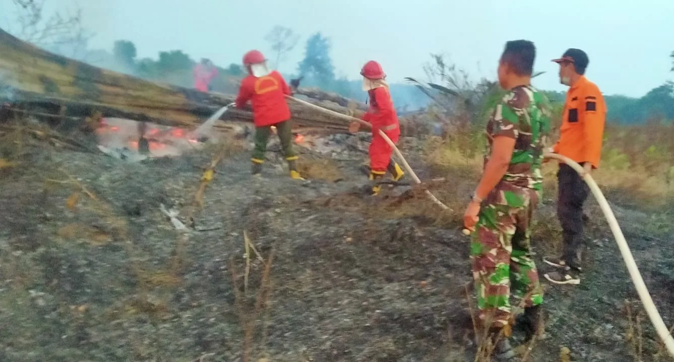 Personel Kodim Sarko bersama Satgas memadamkan api di perkebunan warga Bathin VIII, Sarolangun, Jambi. (DETAIL/ist)