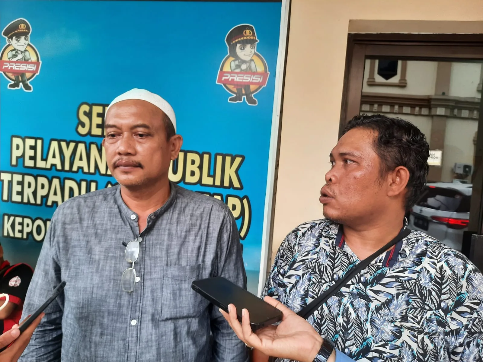 Iskandar (kopiah putih) usai laporkan CV Karo-karo. (DETAIL/ist).