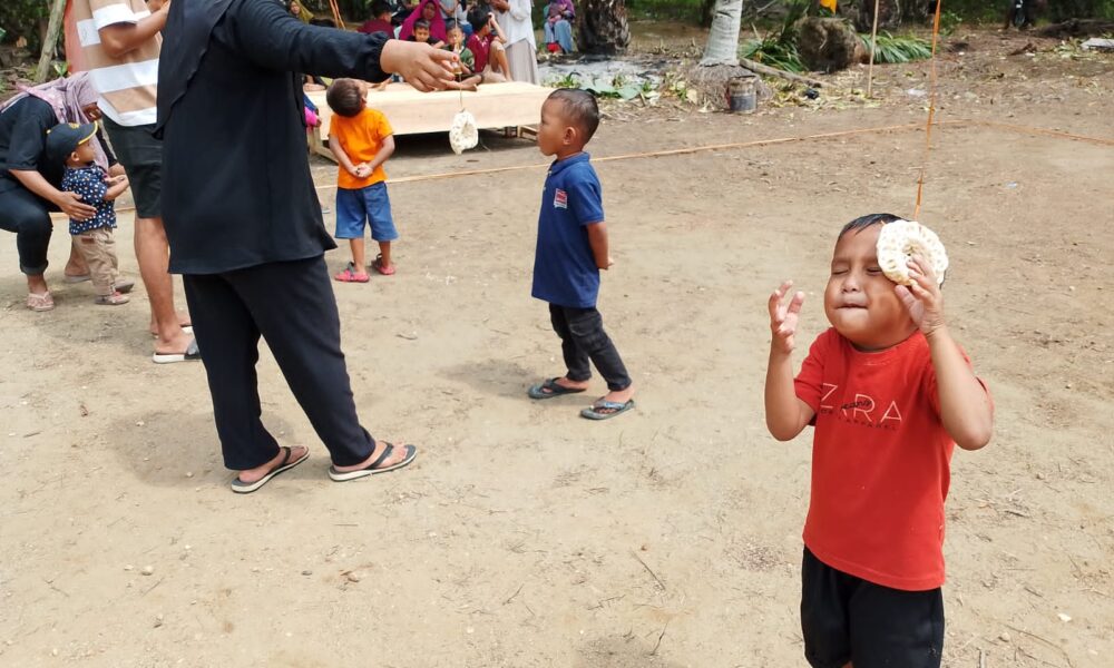 Makan kerupuk anak-anak, salah satu lomba pada HUT RI ke-79 diselenggarakan di RT Selawe.(DETAIL/Daryanto)